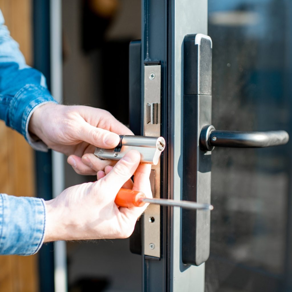 Man installing a new door lock