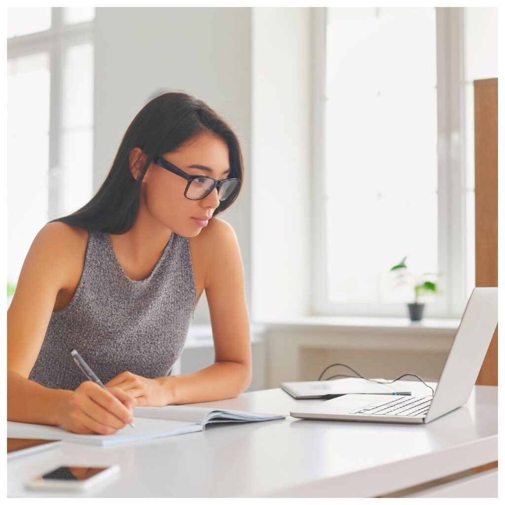 a woman doing research on a laptop