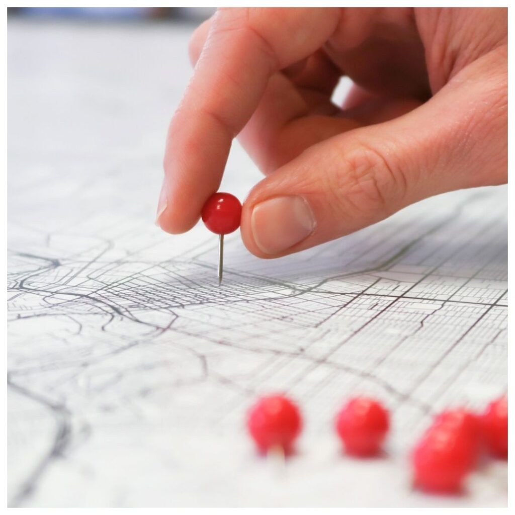 a person adding pins to a map